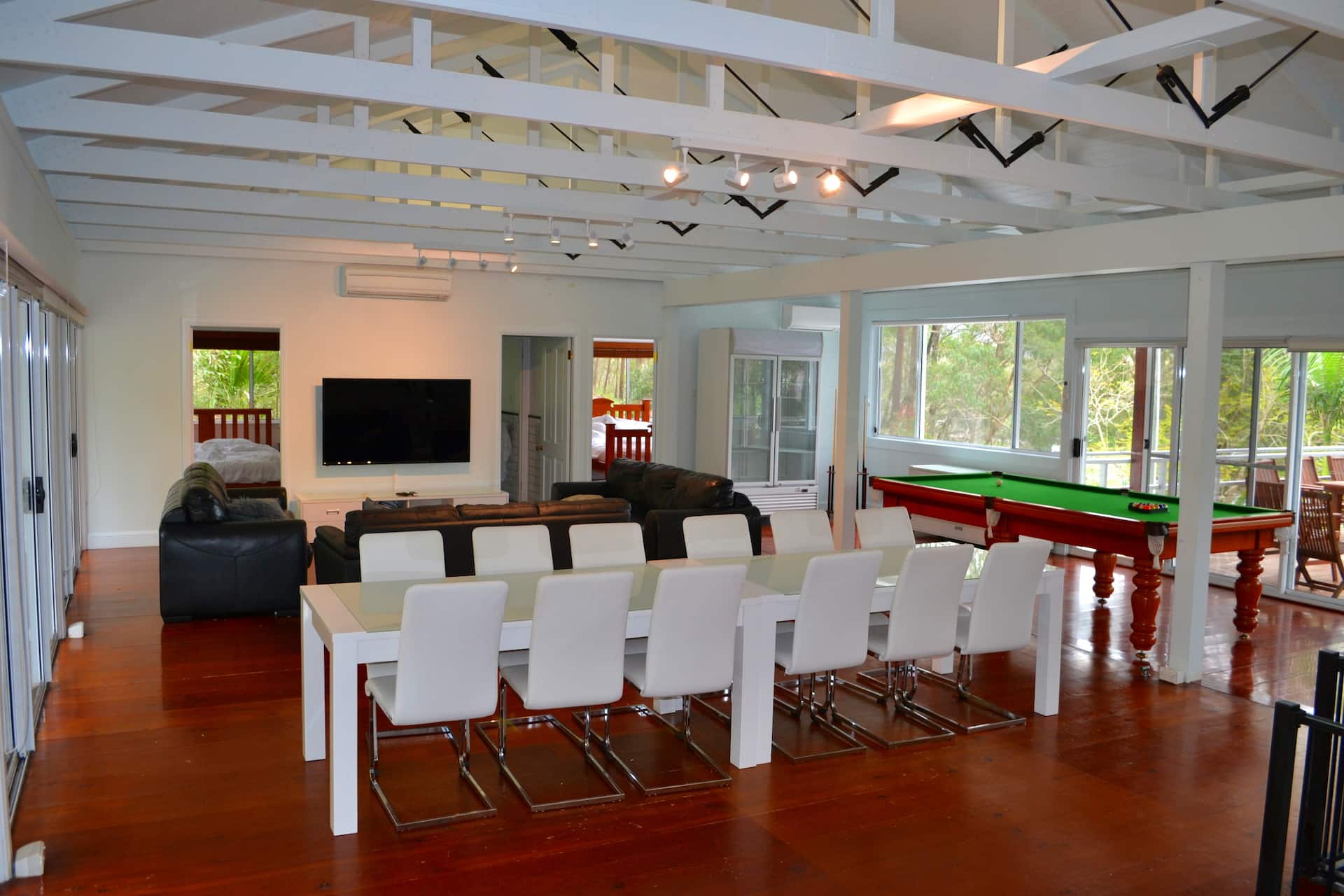Interior of the lodge with stone fireplace, vaulted ceilings and river views